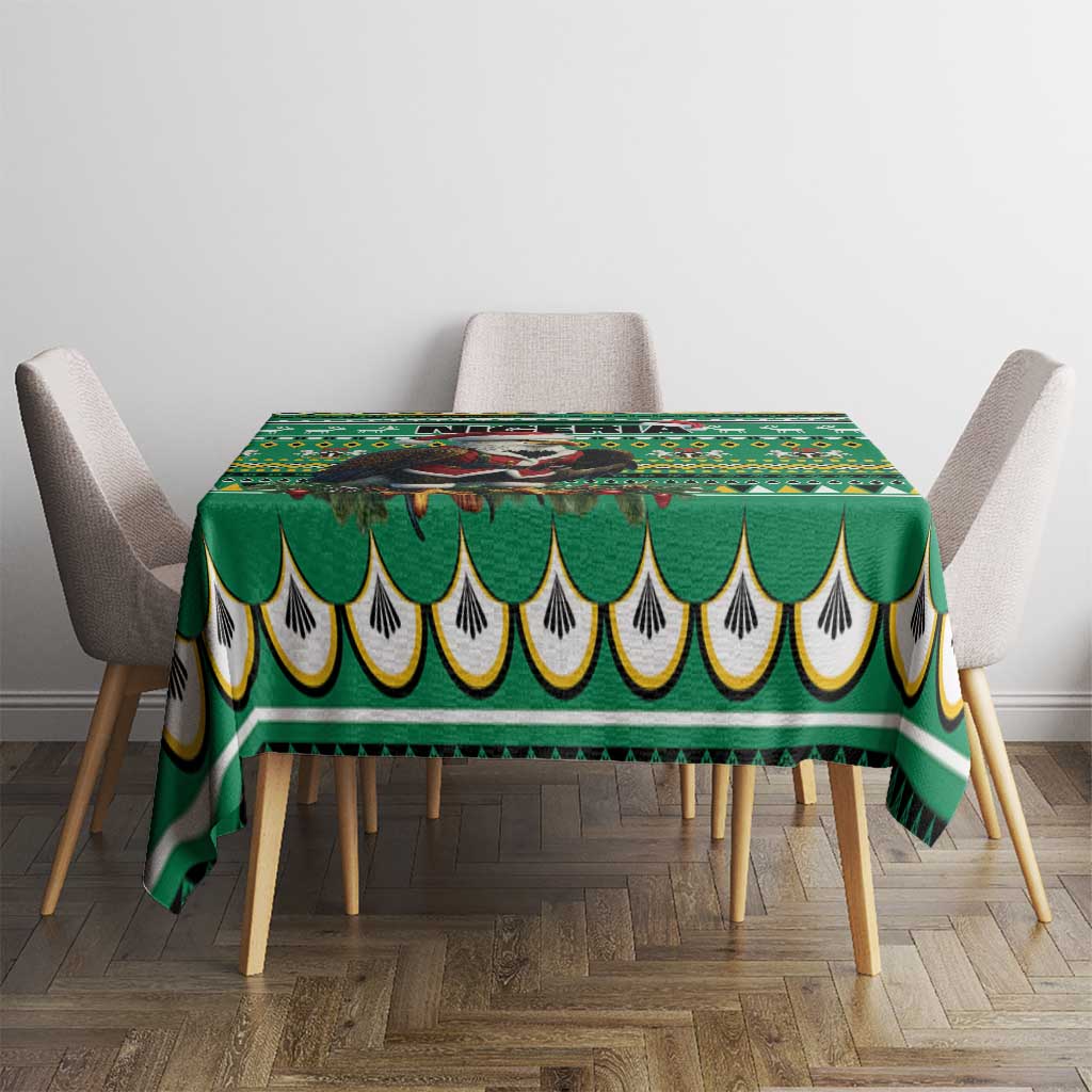 Green tablecloth with scalloped hem and multicolor geometric pattern on dining table
