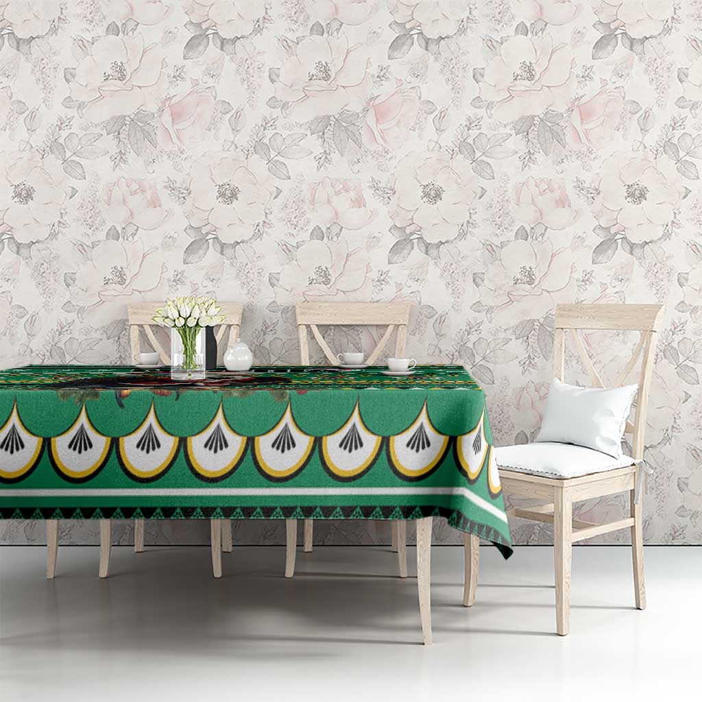 Green tablecloth with scalloped edge and diamond/triangle geometric pattern on dining set