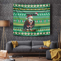 Green Christmas tapestry showing Santa eagle holding red, 'NIGERIA' banner, and border icons