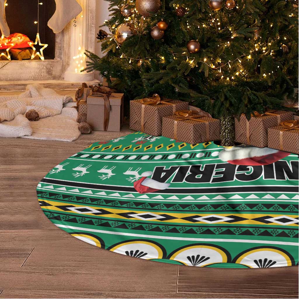 Green round tree skirt with eagle-and-Santa African pattern and tassel fringe detail