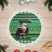 Green round tree skirt with eagle-and-Santa African pattern and white tassel fringe border
