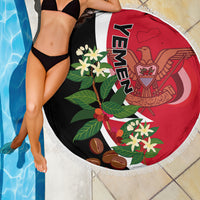 Round beach blanket by pool, black red white Yemen emblem and flowers, fringed border