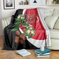 Red, black, and white Yemen flag-style blanket draped over sofa with floral crest art.