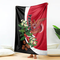Yemen flag-style blanket hanging vertically, red and white with black panel and crest design.