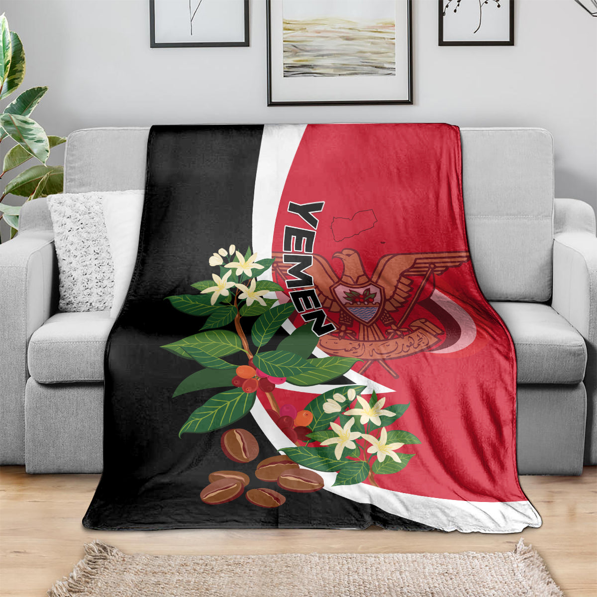 Yemen flag-style blanket on gray sofa: red center, black borders, and crest print.