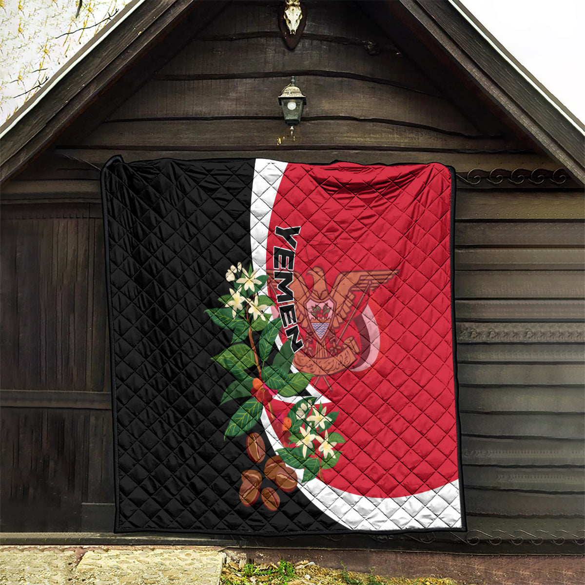 Yemen Unification Day 2024 quilt hanging on porch, red and black with white curved band