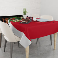 Red and black printed tablecloth with floral accents and diagonal white stripe.