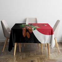 Red, black, and white diagonal tablecloth with Yemen crest and decorative flowers.