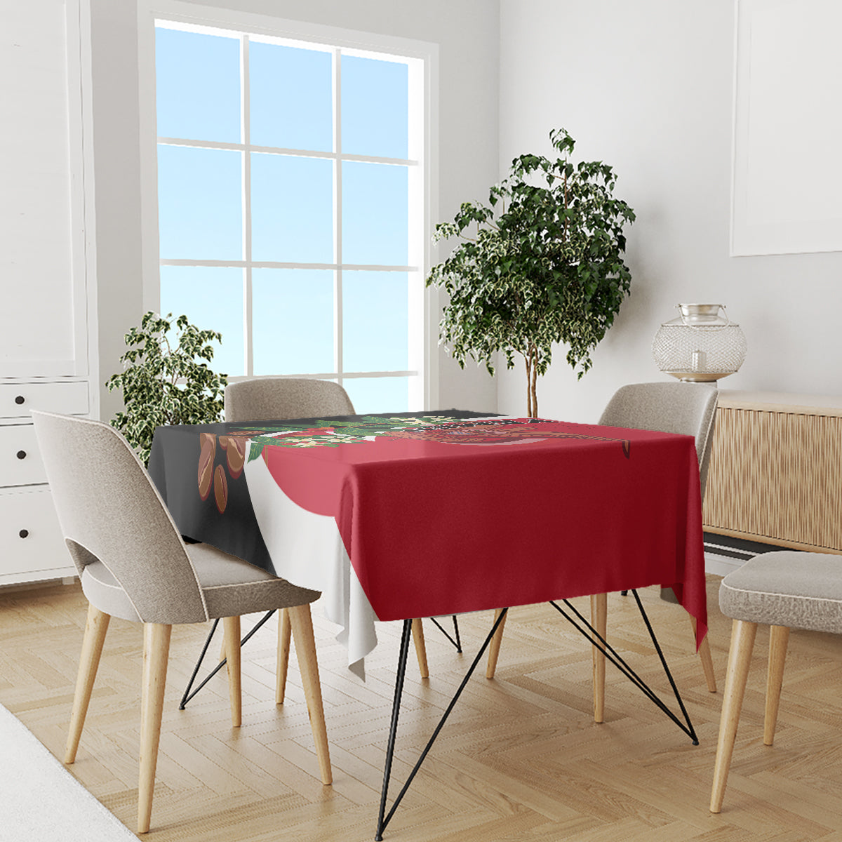 Red tablecloth with diagonal white stripe and black corner, featuring floral and crest print.