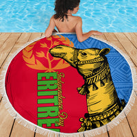 Round beach blanket with fringed edge, red and blue design featuring yellow camel on wooden deck