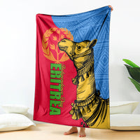 Eritrea Independence Day blanket draped on floor, red and blue with gold camel artwork