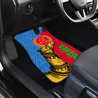Car floor mat close-up: Eritrean camel and flag graphic on blue patterned base