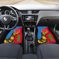 Car interior with two front floor mats featuring Eritrean camel and flag artwork
