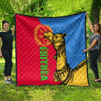 Outdoor quilt display: red, blue, and yellow quilt with golden camel and Eritrea text.