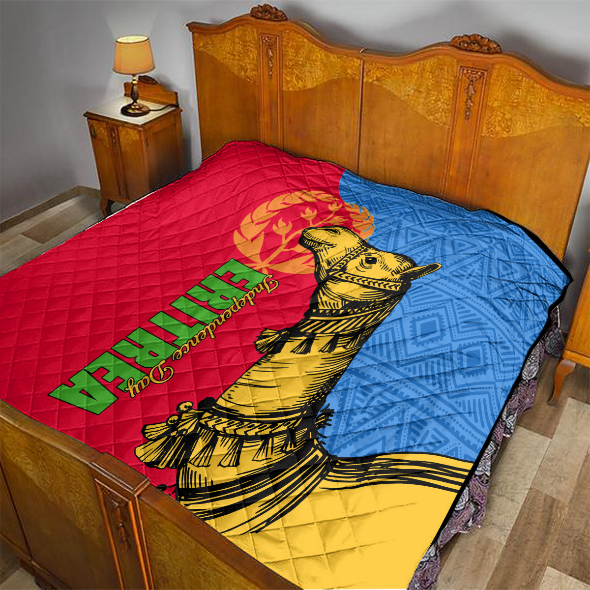Quilt on bed in red, blue, and yellow featuring golden camel artwork and Eritrea text.