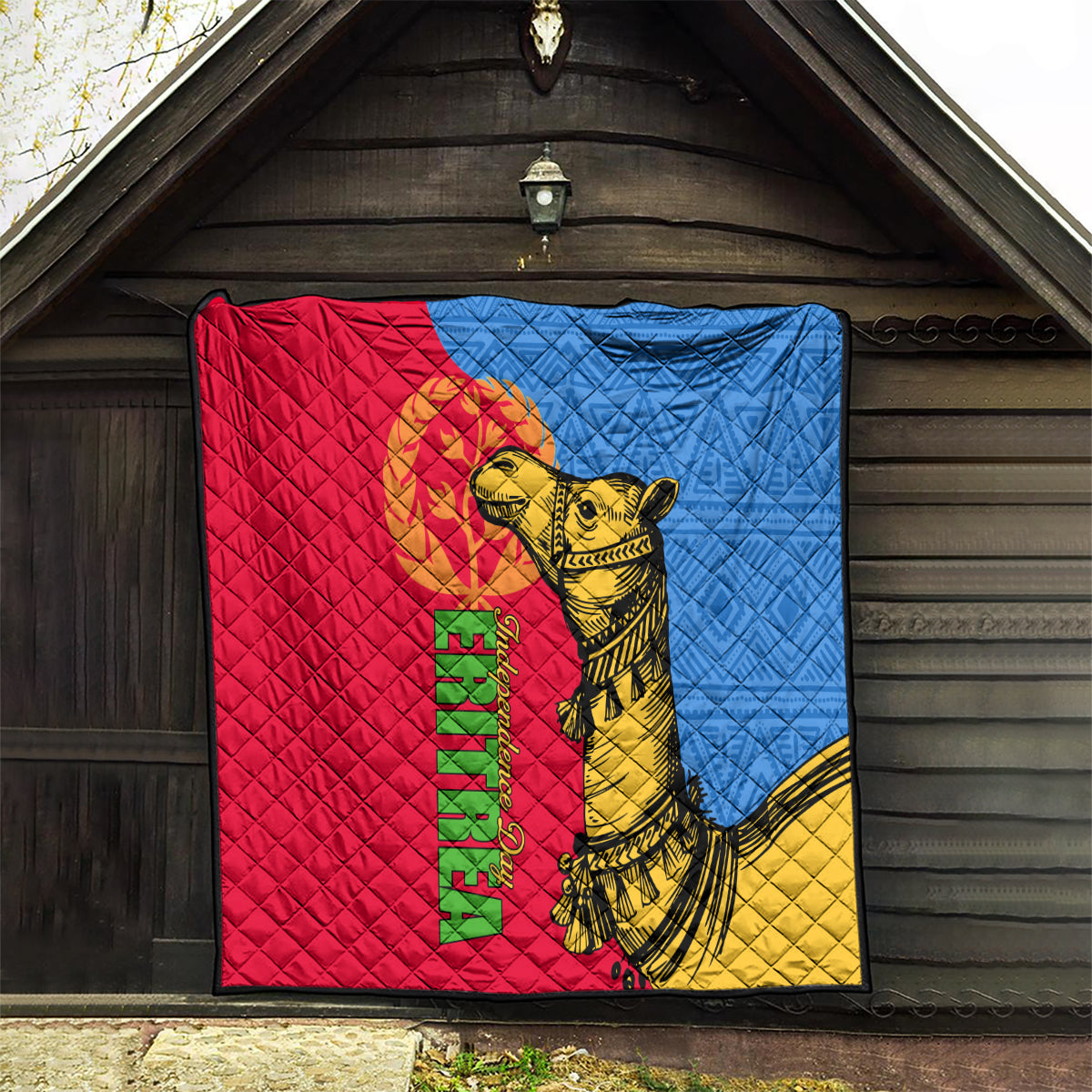 Quilt with red, blue, and yellow panels featuring a golden camel and Eritrea text.