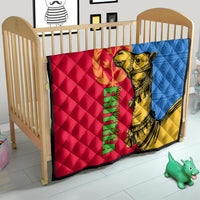 Quilt on toddler bed featuring red, blue, and yellow panels with golden camel graphic.