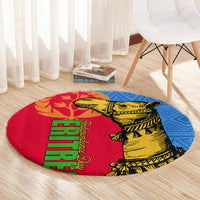 Round rug with camel graphic in yellow on red, blue border, and vertical green text strip