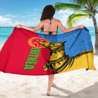 Spread sarong fabric showing yellow camel over blue diamonds with red panel and green text