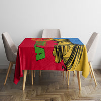 Camel and geometric Eritrean-style tablecloth on dining table, red yellow and blue