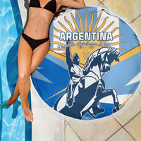 Blue circular beach blanket with fringe edge, Argentina text and warrior illustration
