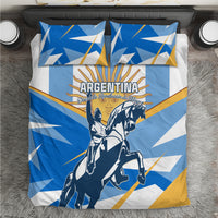 Blue Argentina Revolution Day bedding set on bed with rider artwork, two pillow shams, and flat sheet.