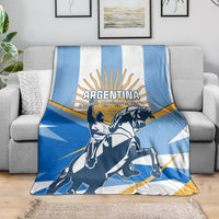 Blue and white Argentina Revolution Day blanket draped over sofa