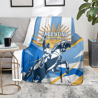 Blue and white Argentina blanket over chair with rider and sunburst