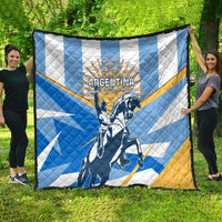 Blue, white, and yellow Argentina Revolution Day quilt with warrior rider graphic, spread outdoors