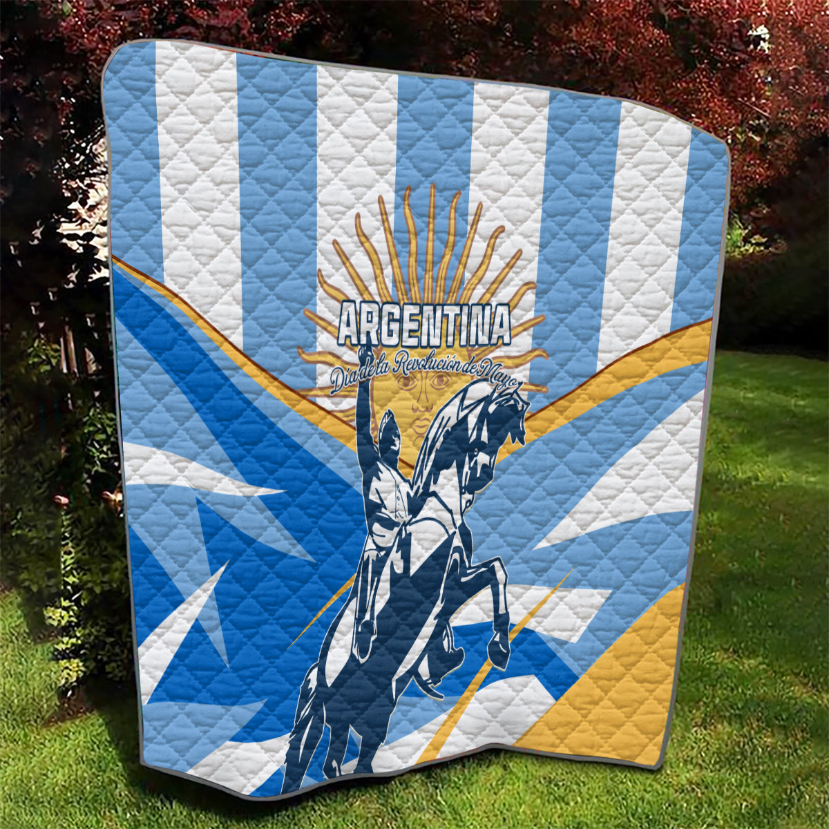 Argentina Revolution Day quilt with blue and white pattern, yellow accents, and rider artwork