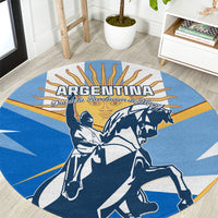Blue round carpet with Argentina wordmark and revolution figures on horseback in navy and white