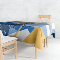 Blue tablecloth with gold and white geometric stripes, draped over dining table