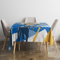 Blue tablecloth with central Argentina graphic and gold accents on dining table