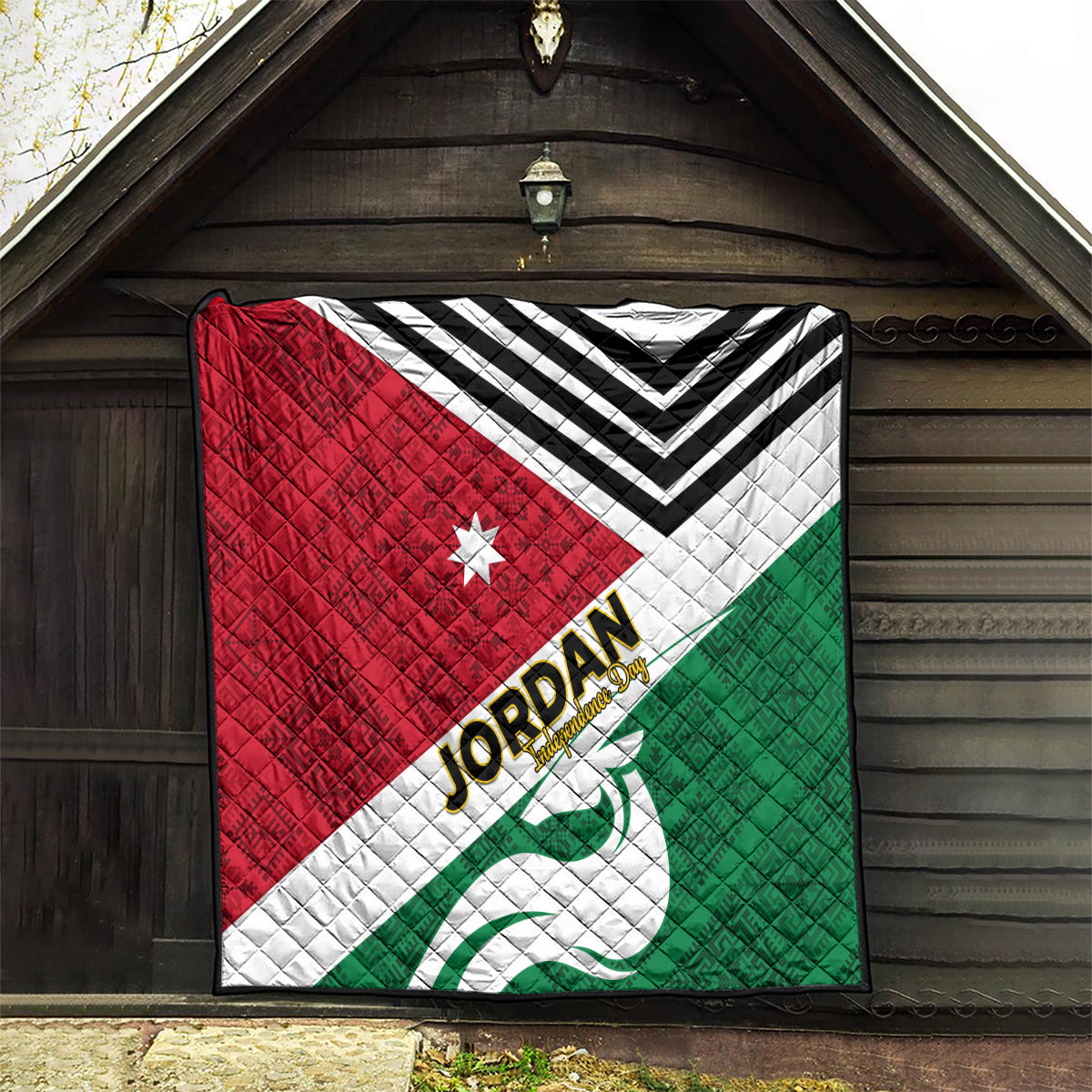 Jordan Independence Day quilt displayed on wall, red and green pattern with white chevrons