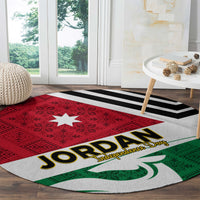 Round rug with red-and-green folk design, white center, Jordan text, and black stripe
