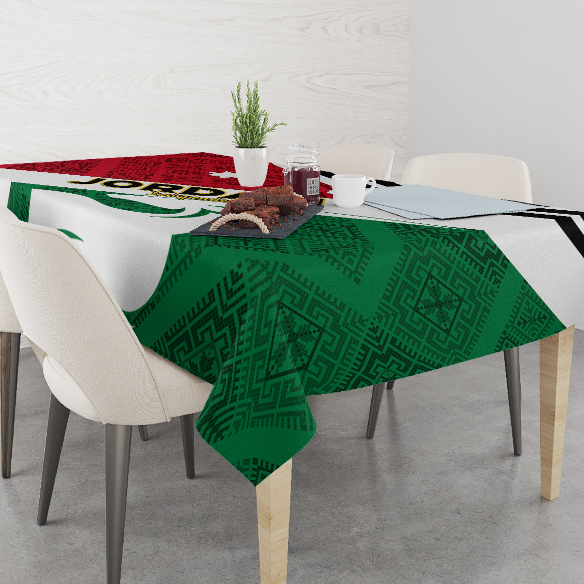 Green tablecloth with patterned center, red stripe, and black outline on dining table