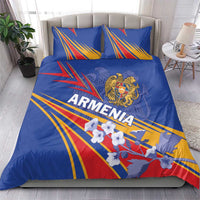 Blue bedding set with two pillows; Armenia lettering, gold crest, and red yellow ray lines