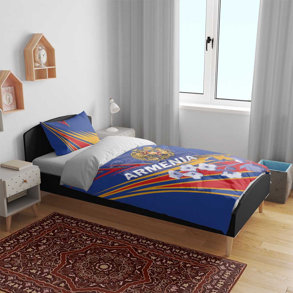 Blue Armenia bedding set with duvet and pillow; crest and ray-striped design on bed