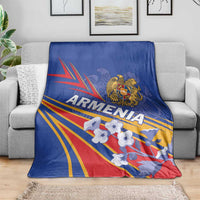 Blue blanket on gray sofa with Armenia eagle crest and bold patriotic stripe design