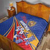Blue quilted Armenia flag bedspread draped over a bed