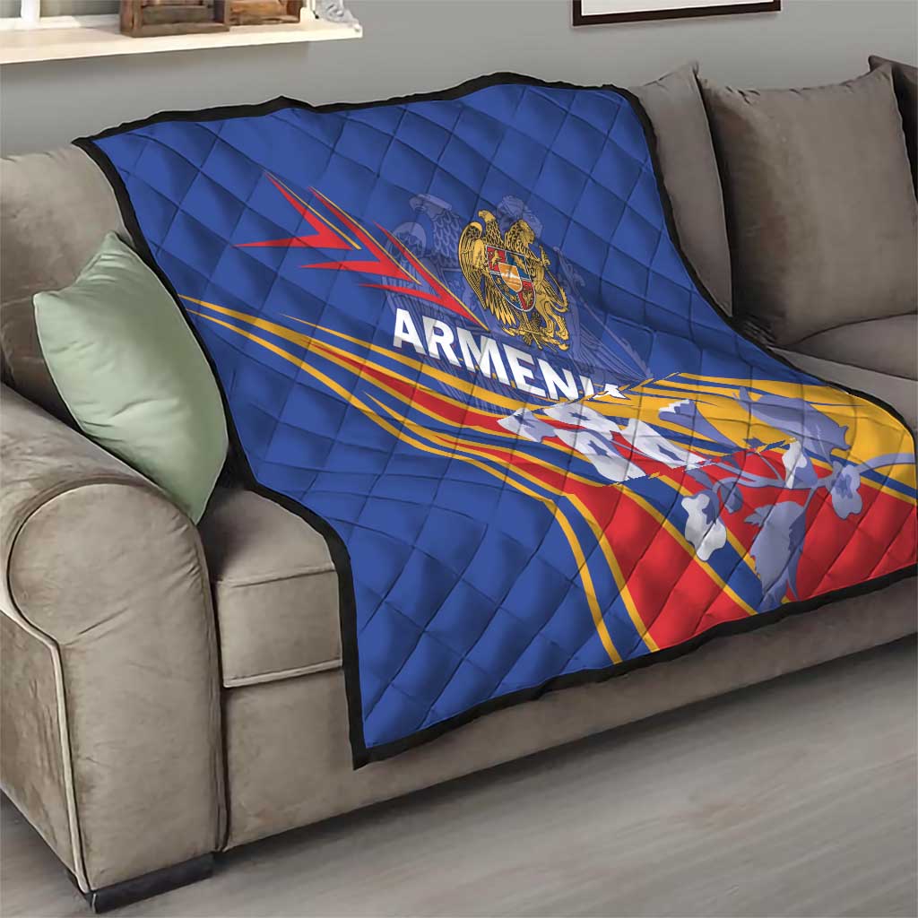 Blue quilted Armenia flag blanket on a gray sofa