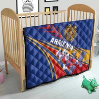 Blue quilted Armenia flag blanket on a wooden baby bed