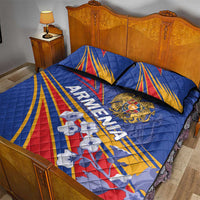 Blue quilt bed set with Armenia text, crest badge, and pillow set on frame
