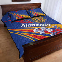 Blue quilt bed set with Armenia lettering, crest emblem, and flag stripe design