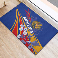 Blue rubber doormat with Armenia lettering, crest, and multicolor rays and white flowers
