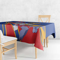 Blue tablecloth with red, yellow, and white geometric stripes and illustrated figures.