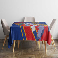 Blue rectangular tablecloth with red and yellow border stripes and illustrated crest figures.