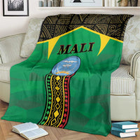Green Mali-themed blanket on sofa featuring 'MALI' banner and patterned panel