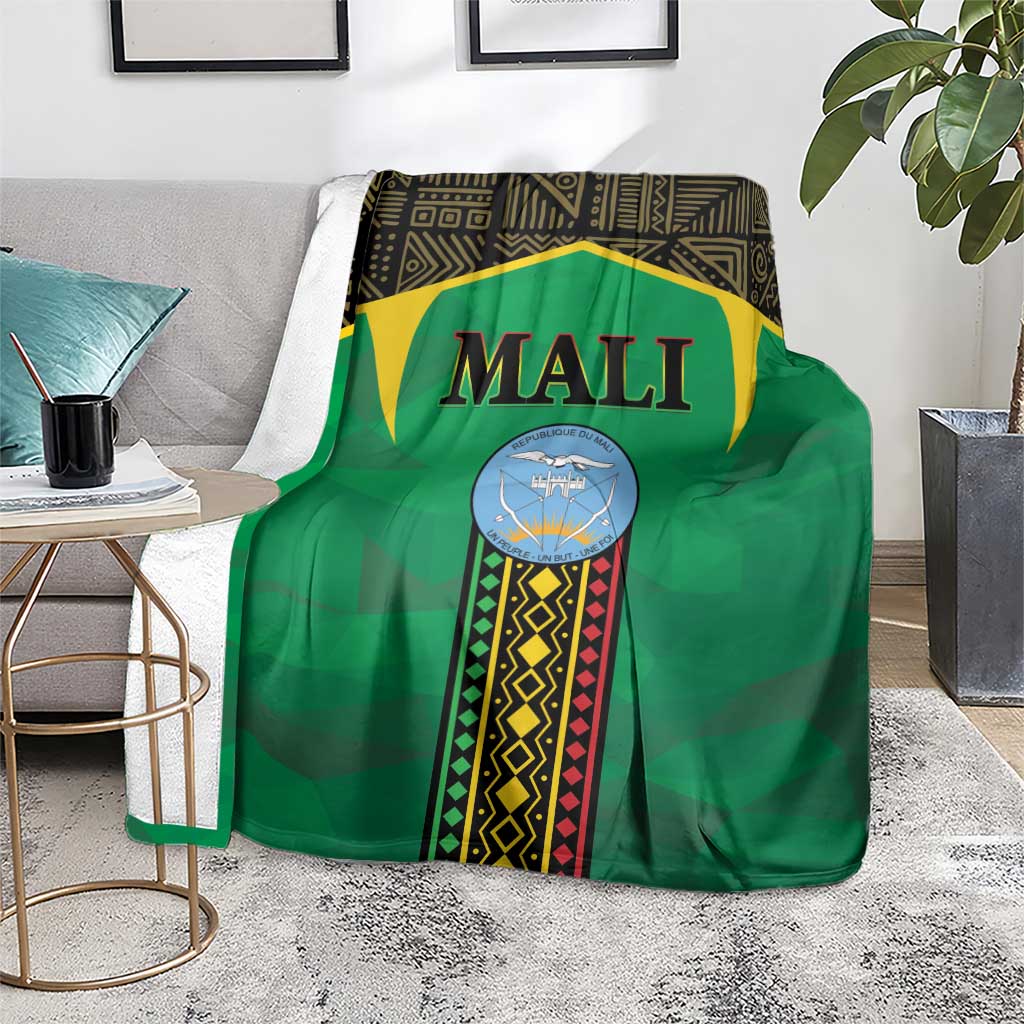 Green Mali-themed blanket draped over chair with 'MALI' logo and border stripes