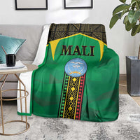 Green Mali-themed blanket draped over chair with 'MALI' logo and border stripes